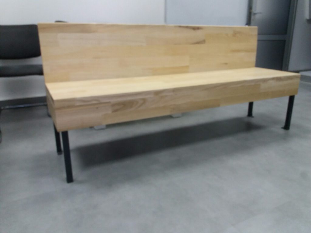 A cute bench made out of wood and metal